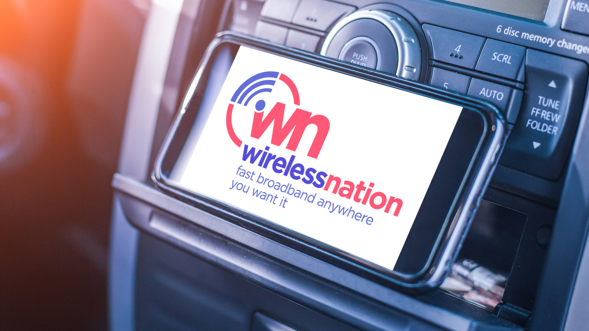 WN logo on smartphone in car holder